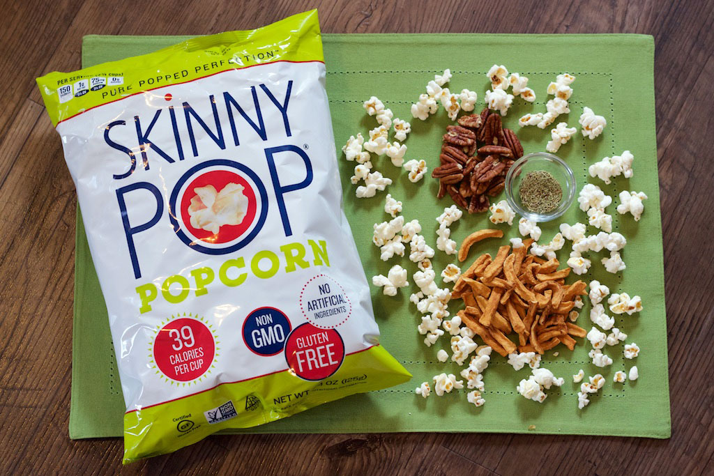 SkinnyPop popcorn bag with pecans, dried apples, and rosemary