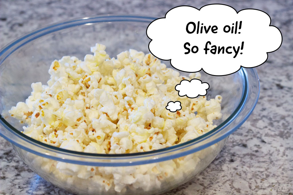 Popcorn in bowl saying olive oil, so fancy!